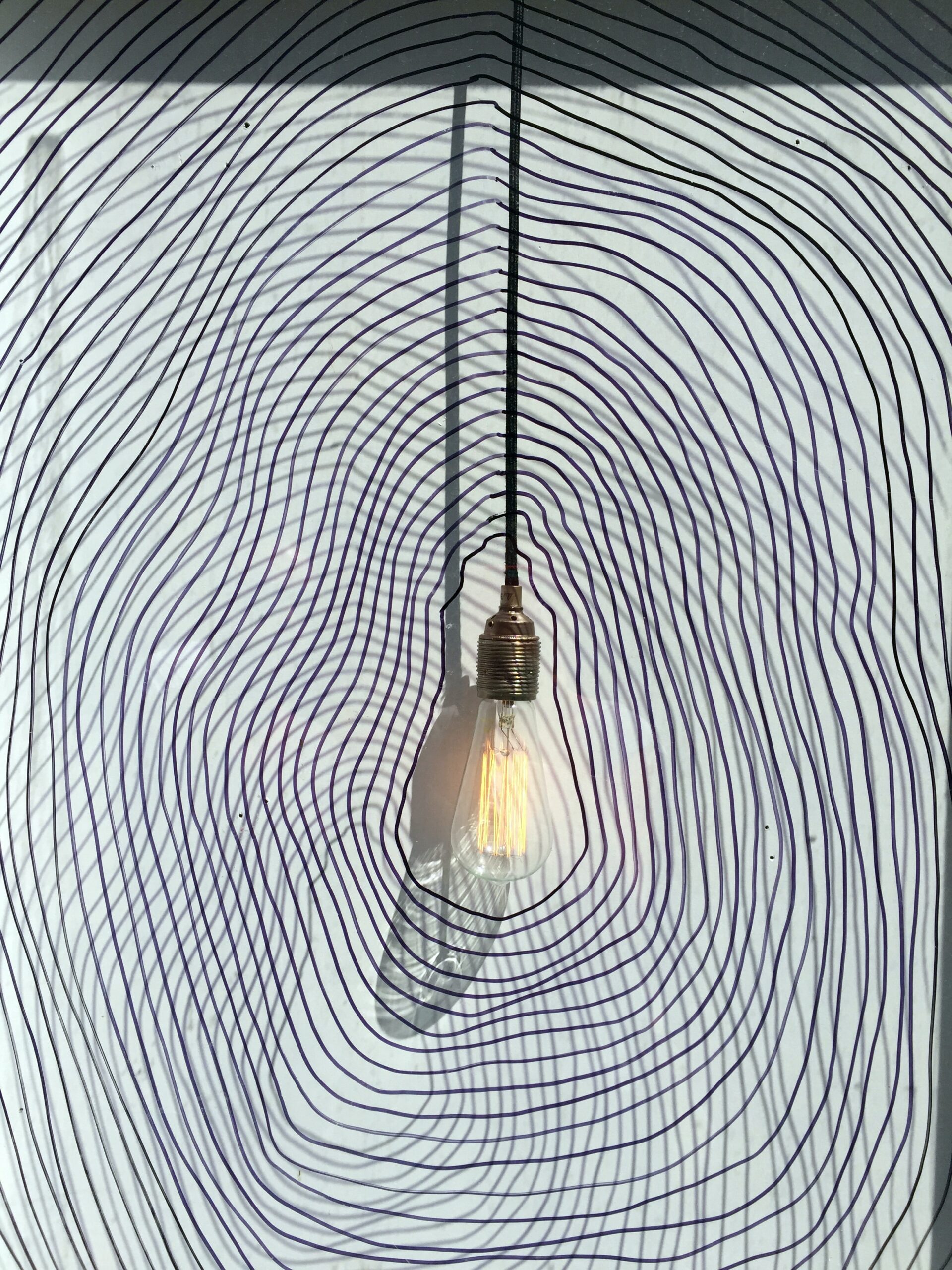 lightbulb with illustrative lights rippling